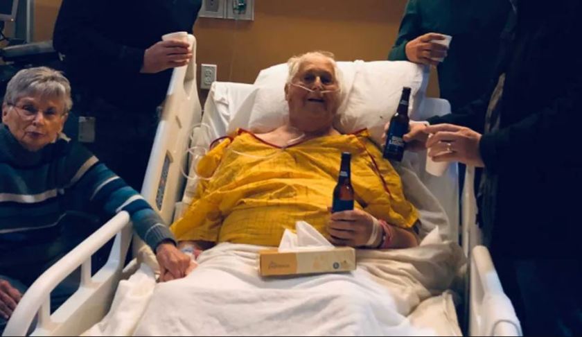In a heartwarming photo that has now gone viral, Norbert Schemm was pictured with his sons having a beer inside a hospital room a day before his death. (Credit: CBS News)