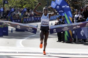 Joyciline Jepkosgei, of Kenya, crosses the finish line to win the Pro Women's Division of the New York City Marathon, in New York's Central Park, Sunday, Nov. 3, 2019. (AP Photo/Richard Drew)