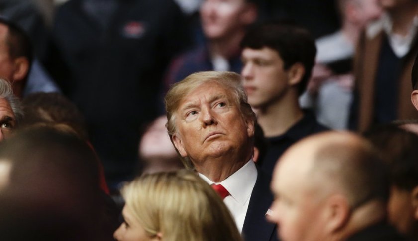 President Donald Trump watches a replay of a lightweight mixed martial arts bout between Kevin Lee and Gregor Gillespie at UFC 244, Saturday, Nov. 2, 2019, in New York. Lee stopped Gillespie in the first round. (AP Photo/Frank Franklin II)