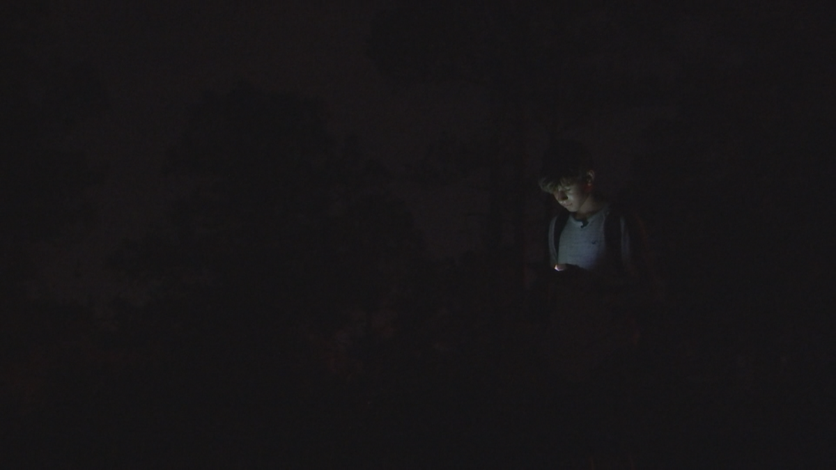 Student waits in the dark for his bus to arrive at his Lehigh Acres stop. (Credit: WINK News)