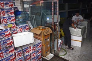 FILE - In this July 12, 2018, file photo, worker pack imported lobsters at the Jingshen seafood market in Beijing. U.S.-Chinese trade contracted again in October, despite optimism about possible progress in talks aimed at ending a tariff war that threatens global economic growth. Chinese imports of U.S. goods fell 14.3% from a year earlier to $9.4 billion, customs data showed Friday, Nov. 8, 2019. (AP Photo/Andy Wong)