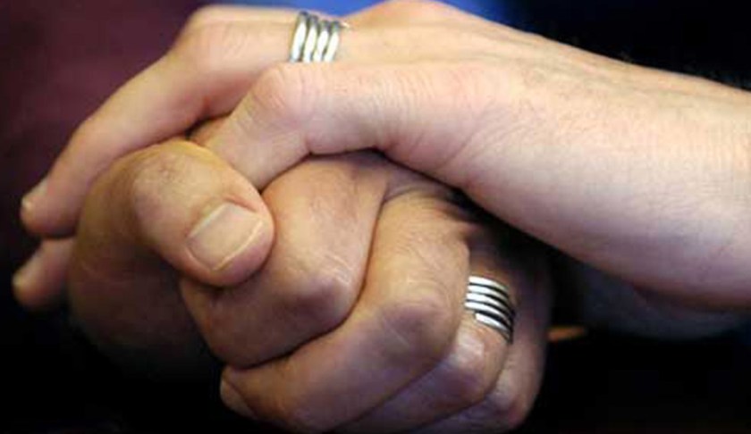 Couple holds hand. (Credit: CBS News)