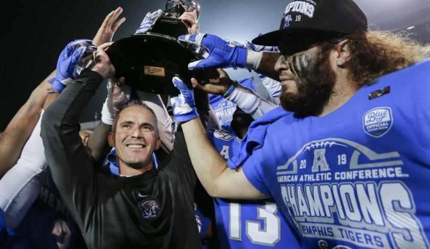 Memphis head coach Mike Norvell, left, celebrates with he team after they defeated Cincinnati in an NCAA college football game for the American Athletic Conference championship Saturday, Dec. 7, 2019, in Memphis, Tenn. (AP Photo/Mark Humphrey)