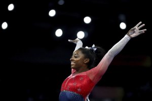 File-This Oct. 8, 2019, file photo shows Simone Biles of the U.S. performs on the vault during the women's team final at the Gymnastics World Championships in Stuttgart, Germany. Biles is the 2019 AP Female Athlete of the Year. She is the first gymnast to win the award twice and the first to win it in a non-Olympic year. (AP Photo/Matthias Schrader, File)