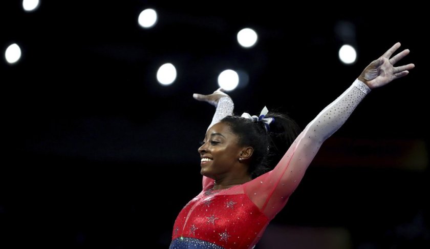 File-This Oct. 8, 2019, file photo shows Simone Biles of the U.S. performs on the vault during the women's team final at the Gymnastics World Championships in Stuttgart, Germany. Biles is the 2019 AP Female Athlete of the Year. She is the first gymnast to win the award twice and the first to win it in a non-Olympic year. (AP Photo/Matthias Schrader, File)