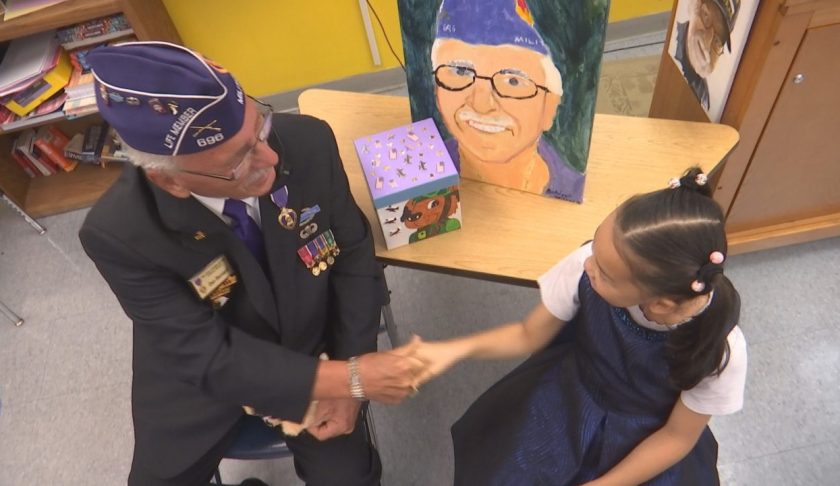 Student and a veteran shake hands. (Credit: WINK News)