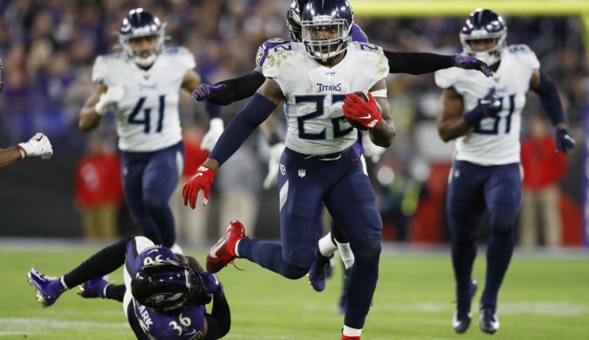 Tennessee Titans running back Derrick Henry (22) runs past Baltimore Ravens strong safety Chuck Clark (36) during the second half of an NFL divisional playoff football game, Saturday, Jan. 11, 2020, in Baltimore. (AP Photo/Julio Cortez)