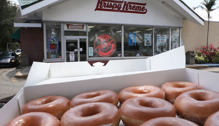 MIAMI, FL - MAY 09: In this photo illustration, Krispy Kreme Donuts are seen outside of a store on May 09, 2016 in Miami, Florida. JAB Holdings Company, announced it is acquiring Krispy Kreme Donuts in a deal valued at $1.35 billion. (Photo illustration by Joe Raedle/Getty Images)