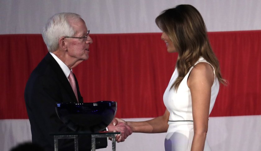 First lady Melania Trump, right, shakes hands with Palm Beach Atlantic University President Bill Fleming, left, after receiving the "Women of Distinction" award at a luncheon, Wednesday, Feb. 19, 2020, in Palm Beach, Fla. (AP Photo/Lynne Sladky)