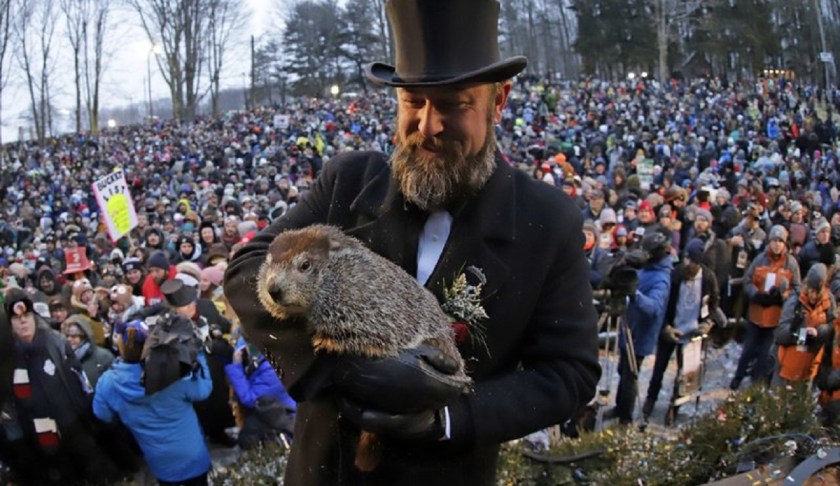 FILE - In this Saturday, Feb. 2, 2019 file photo, Groundhog Club co-handler A.J. Dereume holds Punxsutawney Phil, the weather prognosticating groundhog, during the 133rd celebration of Groundhog Day on Gobbler's Knob in Punxsutawney, Pa. Pennsylvania's most famous groundhog is slated to reveal whether an early spring is on the way or if winter will be staying around. At sunrise on Sunday, Feb 2, 2020 members of Punxsutawney Phil's top hat-wearing inner circle are scheduled to reveal the furry forecaster's prediction. (AP Photo/Gene J. Puskar)