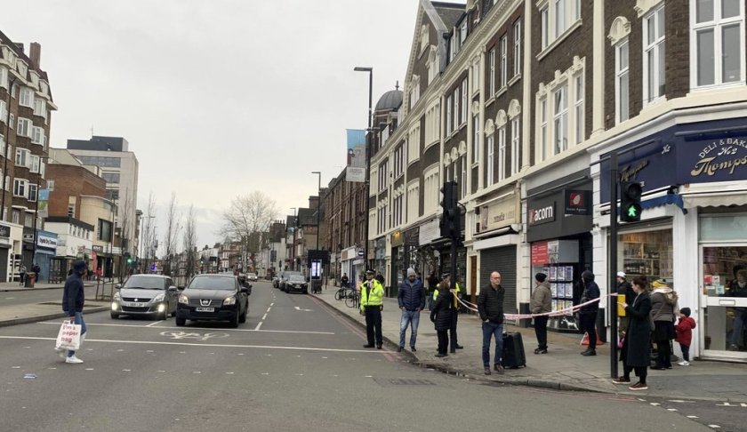 Police attend the scene after an incident in Streatham, London, Sunday Feb. 2, 2020. London police say officers shot a man during a “terrorism-related incident” that involved the stabbings of “a number of people.” (Isobel Frodsham/PA via AP)