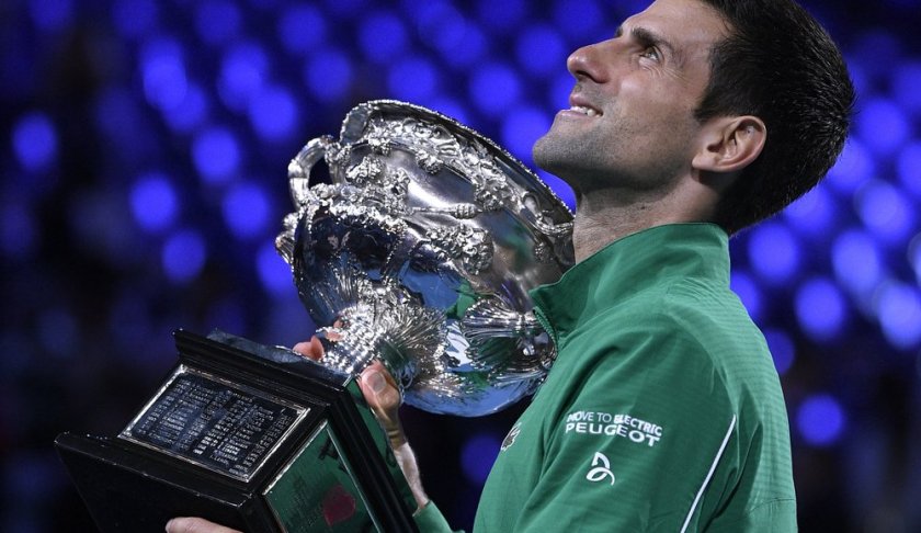 Serbia's Novak Djokovic holds the Norman Brookes Challenge Cup after defeating Austria's Dominic Thiem in the final of the Australian Open tennis championship in Melbourne, Australia, Monday, Feb. 3, 2020. (AP Photo/Andy Brownbill)