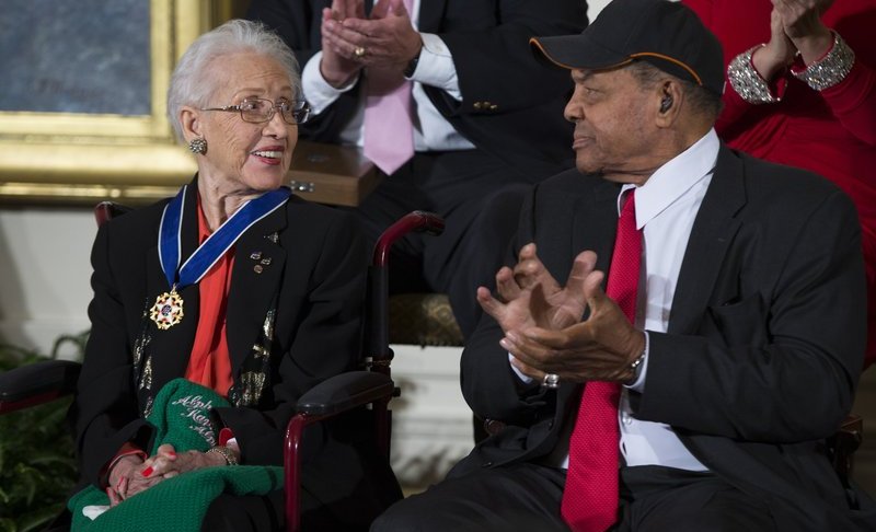 ILE - In a Nov. 24, 2015 file photo, Willie Mays, right, applauds NASA mathematician Katherine Johnson, after she received the Presidential Medal of Freedom from President Barack Obama during a ceremony in the East Room of the White House. (AP Photo/Evan Vucci, File)