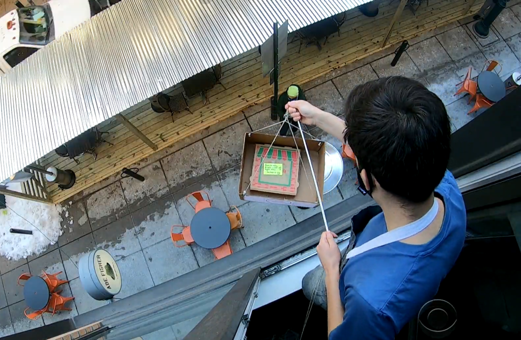 Grad student raises $30,000 for charity dropping pizzas out of his apartment window