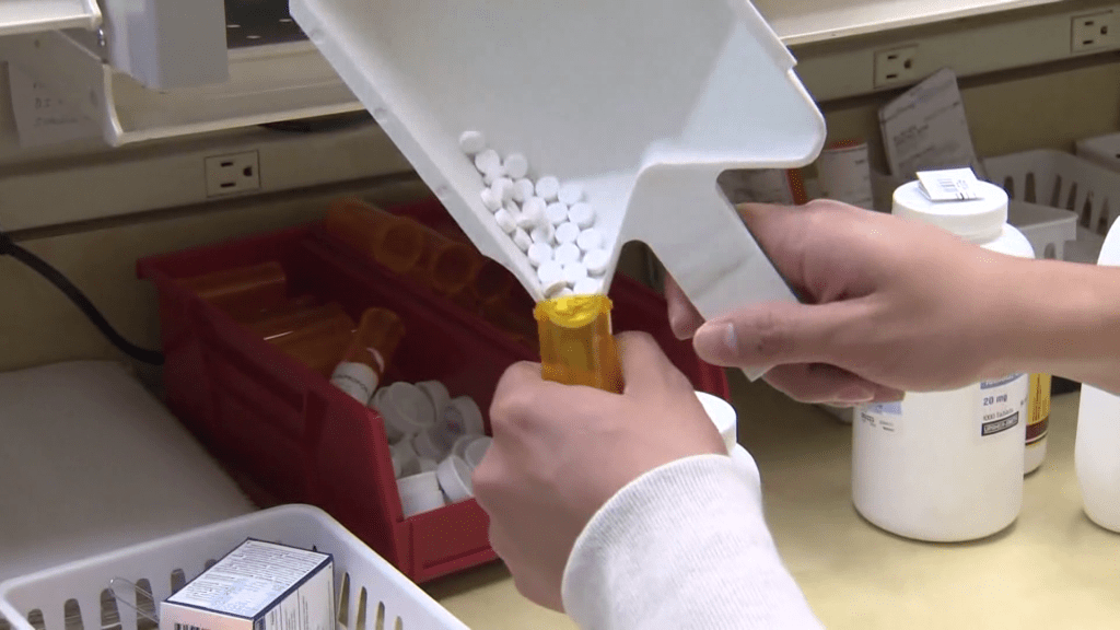 Pharmacist filling a prescription drug