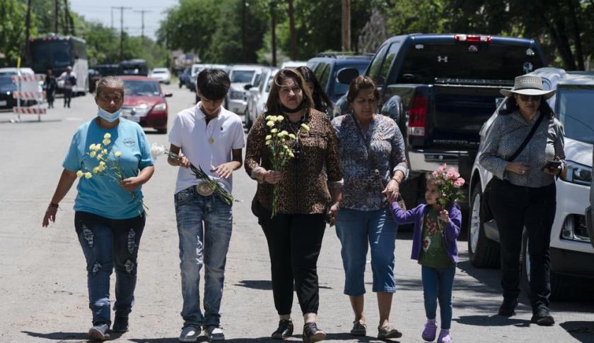 Frustrated onlookers urged police officers to charge into the Texas elementary school where a gunman’s rampage killed 19 children and two teachers, witnesses said Wednesday.
