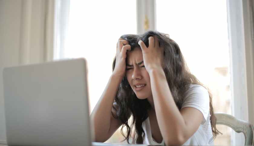 woman in white shirt showing frustration