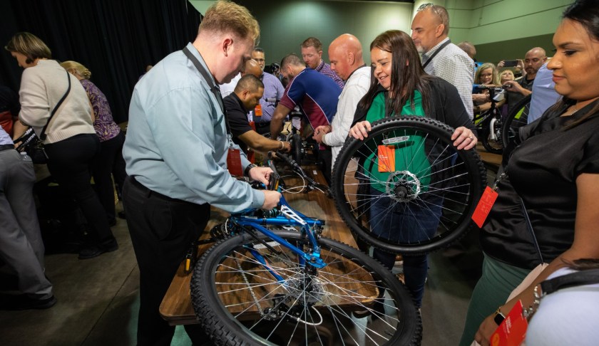 Publix volunteers build bicycles for children in foster care