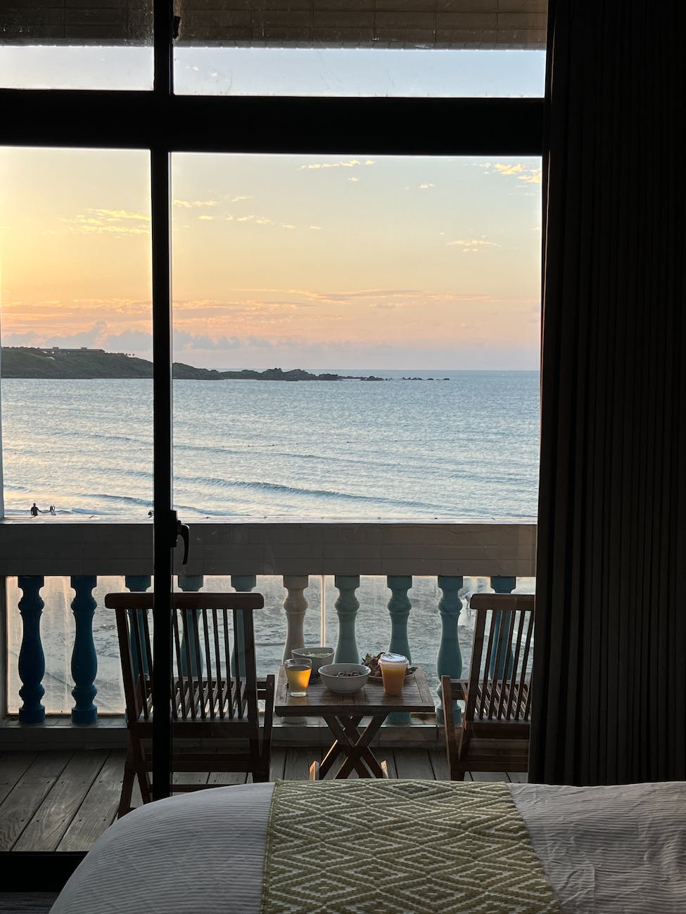 balcony with the view of the sea at sunset