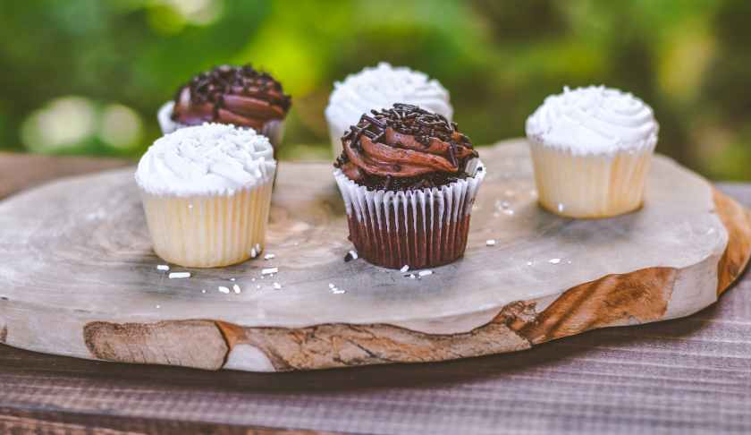 photo of five cupcakes on wooden board