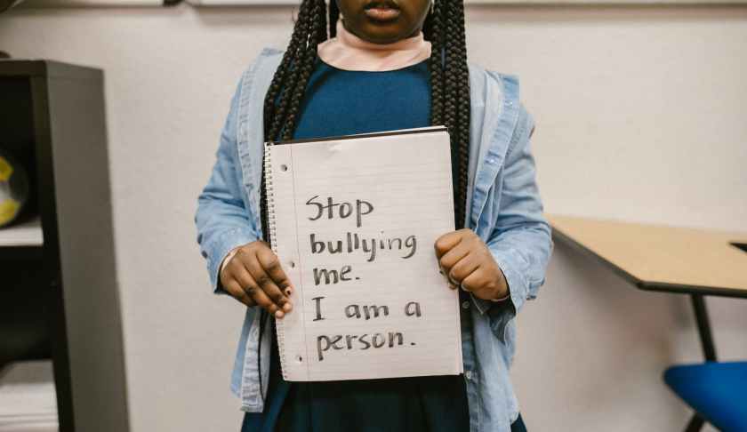 child showing message written in a notebook