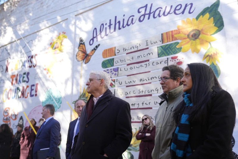 Attorney General Merrick Garland and others tour murals of the shooting victims. (AP Photo/ Eric Gray)