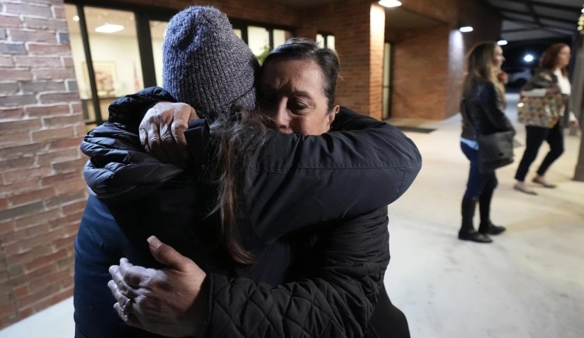 People hug each other after the Uvalde school shooting meeting.