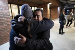 People hug each other after the Uvalde school shooting meeting.
