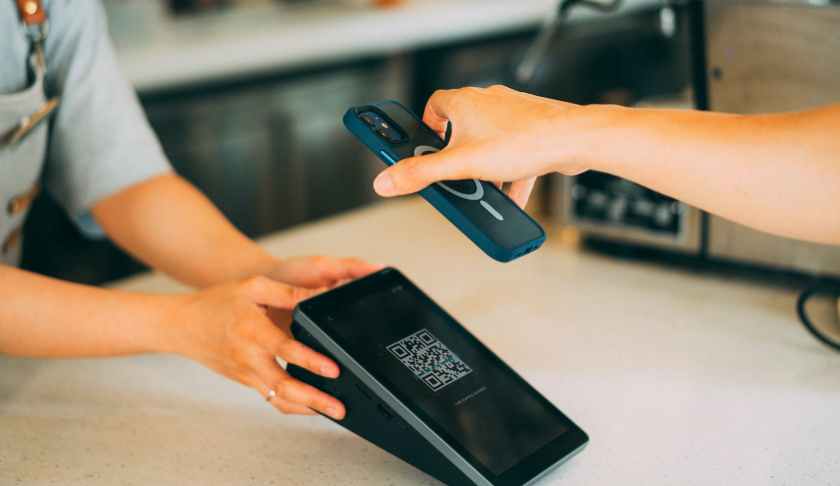 a close up shot of a person scanning a qr code