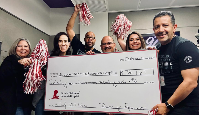 The staff of 97.7 Latino with their check to St. Jude. CREDIT: WINK News
