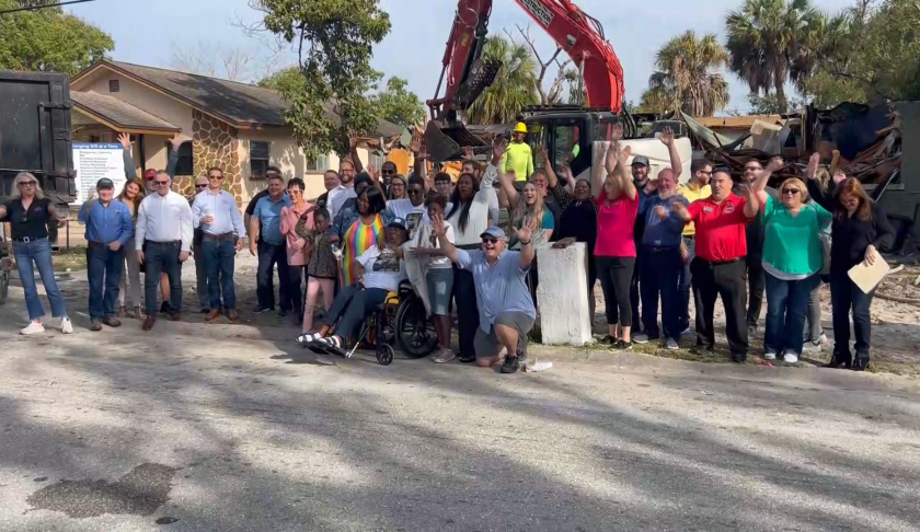 Community partners demolish home.