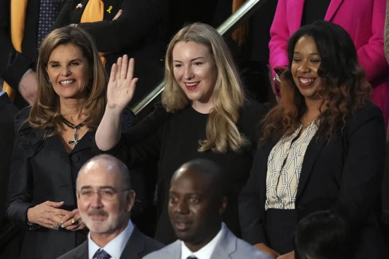 Maria Shriver, left, Kate Cox, of Dallas and Latorya Beasley of Birmingham, Ala., stand before President Joe Biden delivers the State of the Union address. CREDIT: AP