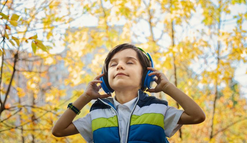 photo of a boy listening in headphones