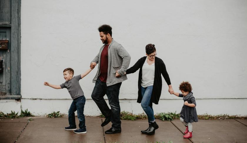 family of four walking at the street