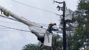 Man fixing power line wires.