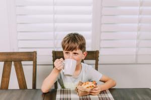 kid drinking from a coffee mug