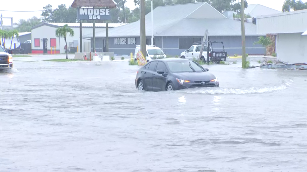 Car driving through flooded road near Fort Myers Beach