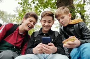 a three boys looking the smartphone