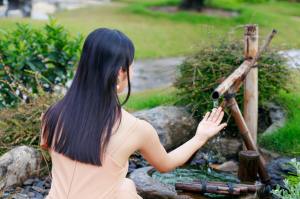 woman crouching by well