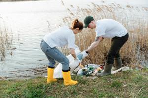 a man and a woman picking up garbage