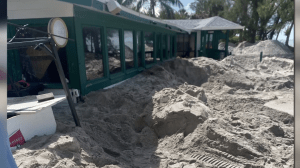 The Mucky Duck surrounded by sand.